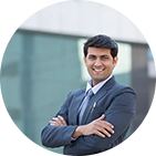 A male office worker standing outside a building